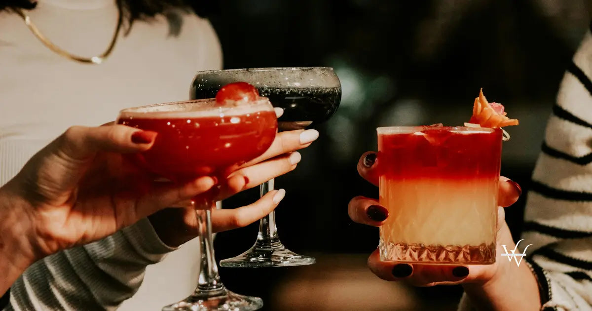 women drinking cocktails together