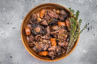 Braised veal oxtail stew with carrots and herbs